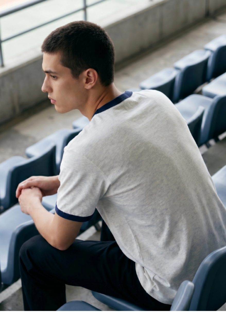 Man sitting alone in an empty stadium seat